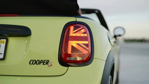 Close up bumper of new light green Mini Cooper S cabriolet model with British Stock Footage 261247485