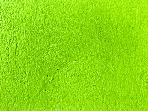 Close-up of bumpy neon green stucco wall surface. Stock Photos
