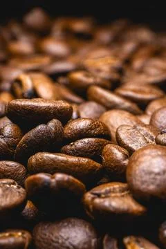 Close up from a bunch of coffee beans laying down Stock Photos