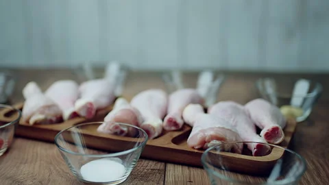 Close-up of a bunch of FRESH RAW ORGANIC CHICKEN DRUMSTICK in 4K Stock Footage 138273412