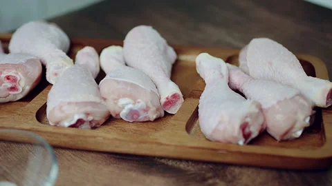 Close-up of a bunch of FRESH RAW ORGANIC CHICKEN DRUMSTICK in 4K Stock Footage 138276391