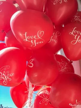 Close up of a bunch red heart shaped balloons with "i love you" text on them. Stock Photos