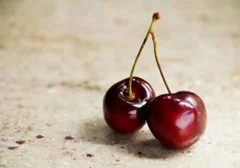 Close up of bunch sweet ripe fresh cherries on a granite table. Stock Photos