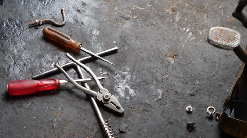 Close up of bunch of tools lying around on garage floor, Bali Stock Footage 140293928