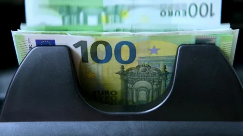Close-up bundle of 100 euro banknotes moving in currency counting machine Stock-Footage 307431496