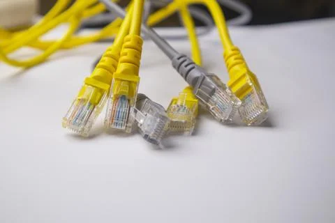 Close-up of a bundle of interconnected yellow and grey Ethernet network cab.. Stock Photos