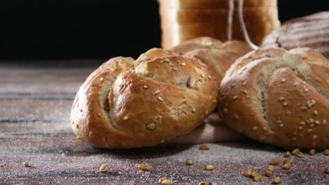 Close up of buns, rye bread and toast bread on wooden table. Close up Stock Footage 137640392