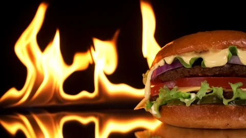 Close-up of a Burger with a fire background. Slow motion. Stock Footage 125655775