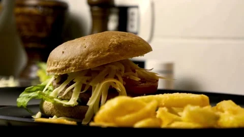 Close-up of burger with juicy tender beef meat and vegetables, turning, Stock Footage 336578838
