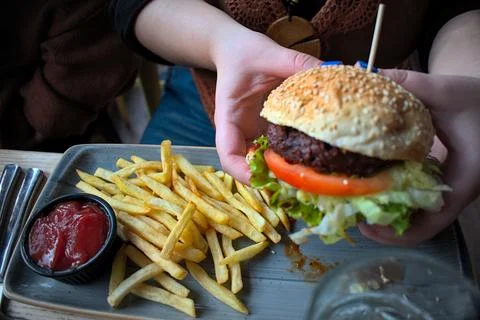 Close up of a burger with salad on the side Photos