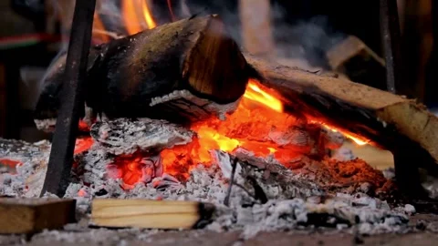 Close up of burning campfire flames and glowing embers Stock Footage 333837157