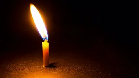 Close-up of burning candle on black background. Time lapse, looping Stock Footage 76048145