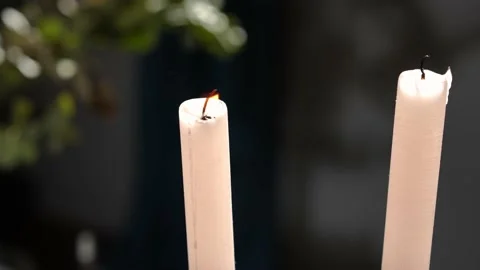 Close-up burning candle blowing out with wind in slow motion. decorative Stock Footage 221863409