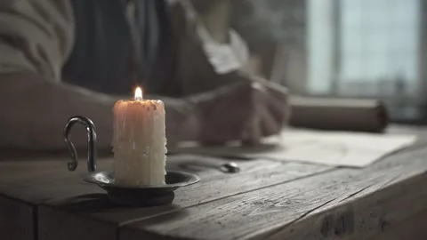 Close up of a burning candle, craftsman hands extinguishing it with a snuffer 스톡 동영상 337929993
