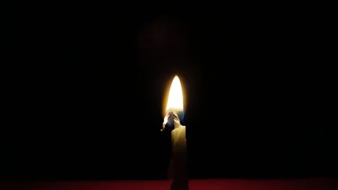 Close-up of a burning candle on a dark background Stock Footage 317900970