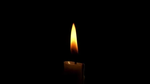 Close up of a burning candle flame isolated on a black background Stock Footage 294948148
