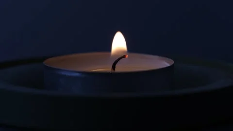 Close-Up of Burning Candle Wick with Flickering Flame in 4K Stock Footage 347652808