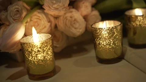Close-up of burning candles on the flower bunch background Stock Footage 172393573