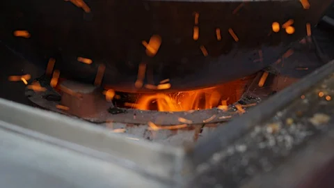 Close-up burning coal in a fire. Bright orange flame burning inside. 4k Stock Footage 111568188