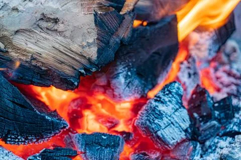 Close-up of a burning fire pit with red embers, dark and light coal colors,.. Stock Photos