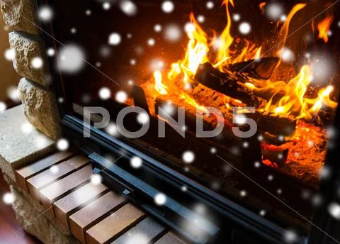 Close up of burning fireplace with snow Stock Photos