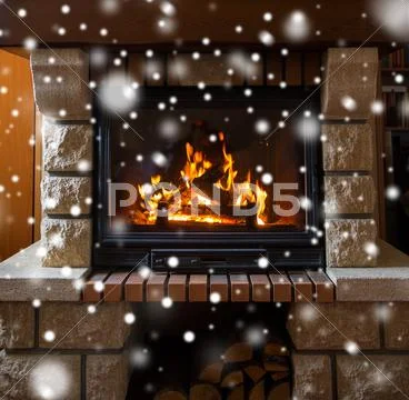 Close up of burning fireplace with snow Stock Photos