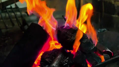 Close-up of burning firewood producing intense flames. 4K Stock Footage 338433003