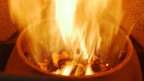 Close-up of burning flames inside the modern pellet stove, yellow and orange Stock Footage 144611727