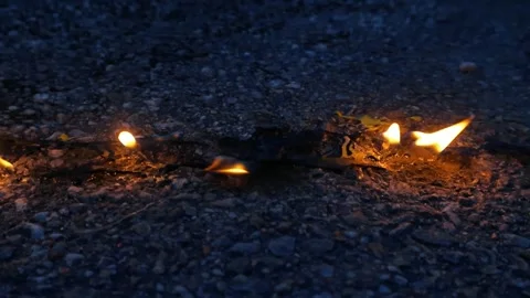 Close Up of Burning Fuse Line on Asphalt Road Stock Footage 336536451