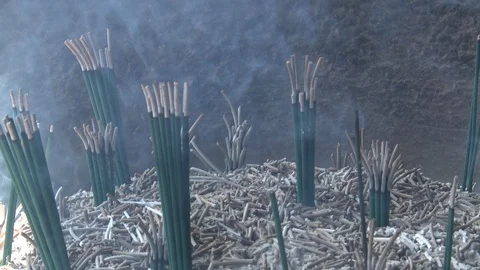 Close up on burning incense in pit at Buddhist temple Video stock 86806065
