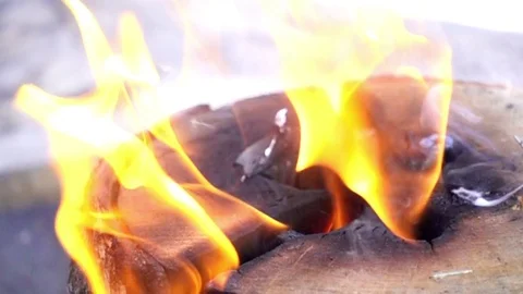 Close-up burning of a large log. Slow motion of orange flame and smoke. Stock Footage 85088743