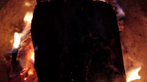 Close-Up of Burning Log with Flames and Smoke in Fire Pit at Night Stock Footage 337694503