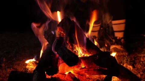 Close-up of burning logs in a cozy bonfire at night Stock Footage 343992174