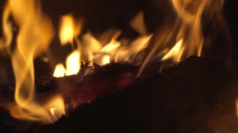 Close-up of burning logs in a fireplace at night  Stock Footage 327153705