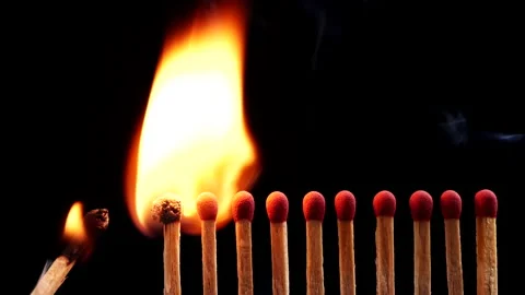 Close up burning match setting fire to a row of unlit matches Stock Footage 149422447