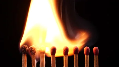 Close up burning match setting fire to a row of unlit matches Stock Footage 149422626