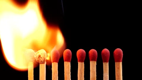 Close up burning match setting fire to a row of unlit matches Stock Footage 149422664