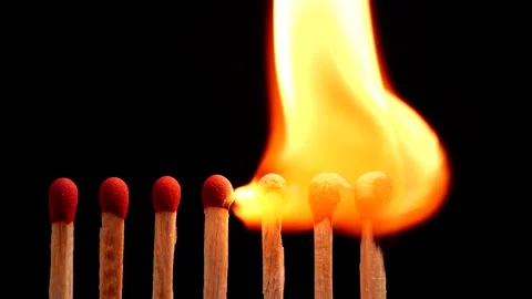 Close up burning match setting fire to a row of unlit matches Stock Footage 149423413