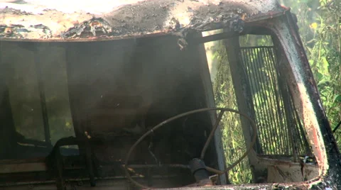 Close up of burning old car in summer forest Stock Footage 64215010