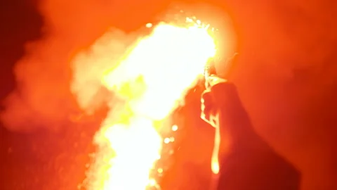 Close-up of a burning signal flare held by a man Stock Footage 85587166