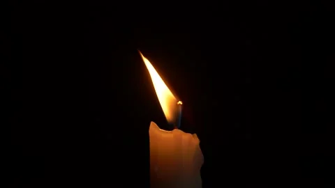 Close-up burning single candle flame isolated on black background, 4K video Vídeos de archivo 146353357