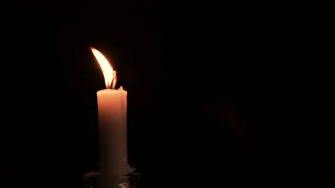 Close-up burning single candle flame isolated on black background, 4K video 스톡 동영상 148064484