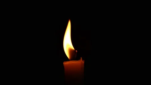 Close-up burning single candle flame isolated on black background, 4K video Vídeo Stock 148456930