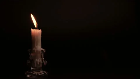 Close-up burning single candle flame isolated on black background, 4K video Stockbeeldmateriaal 149953819