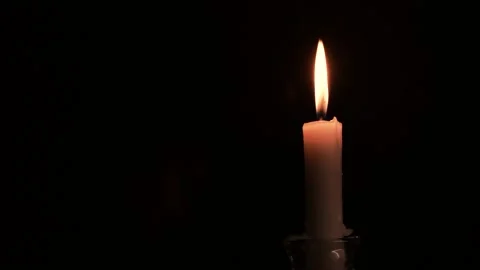 Close-up burning single candle flame isolated on black background, 4K video Vídeo Stock 150346111