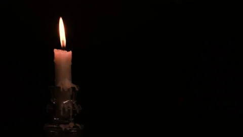 Close-up burning single candle flame isolated on black background, 4K video Stockbeeldmateriaal 151499262