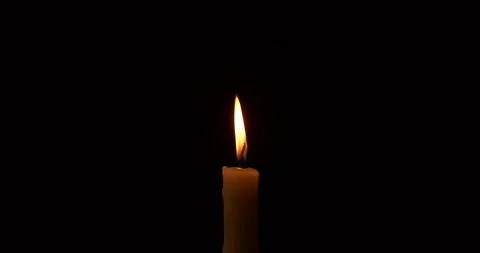Close-up burning single candle flame isolated on black background, 4K video Vídeo Stock 161211143