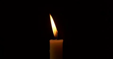 Close-up burning single candle flame isolated on black background, 4K video Stock Footage 164274927