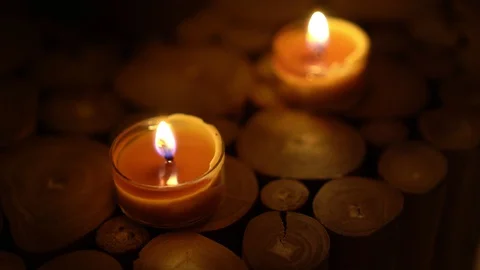 Close-up of burning tea light candle on table in home. Stock Footage 129299611