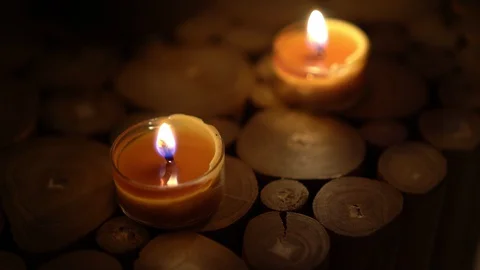 Close-up of burning tealight candle on table in home. Stock Footage 129299468